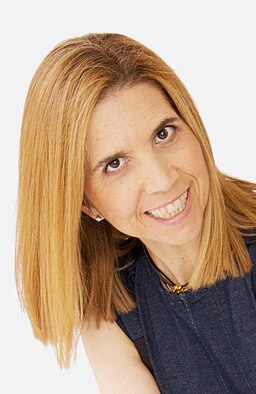 Headshot of Nuria Oliver on a light background